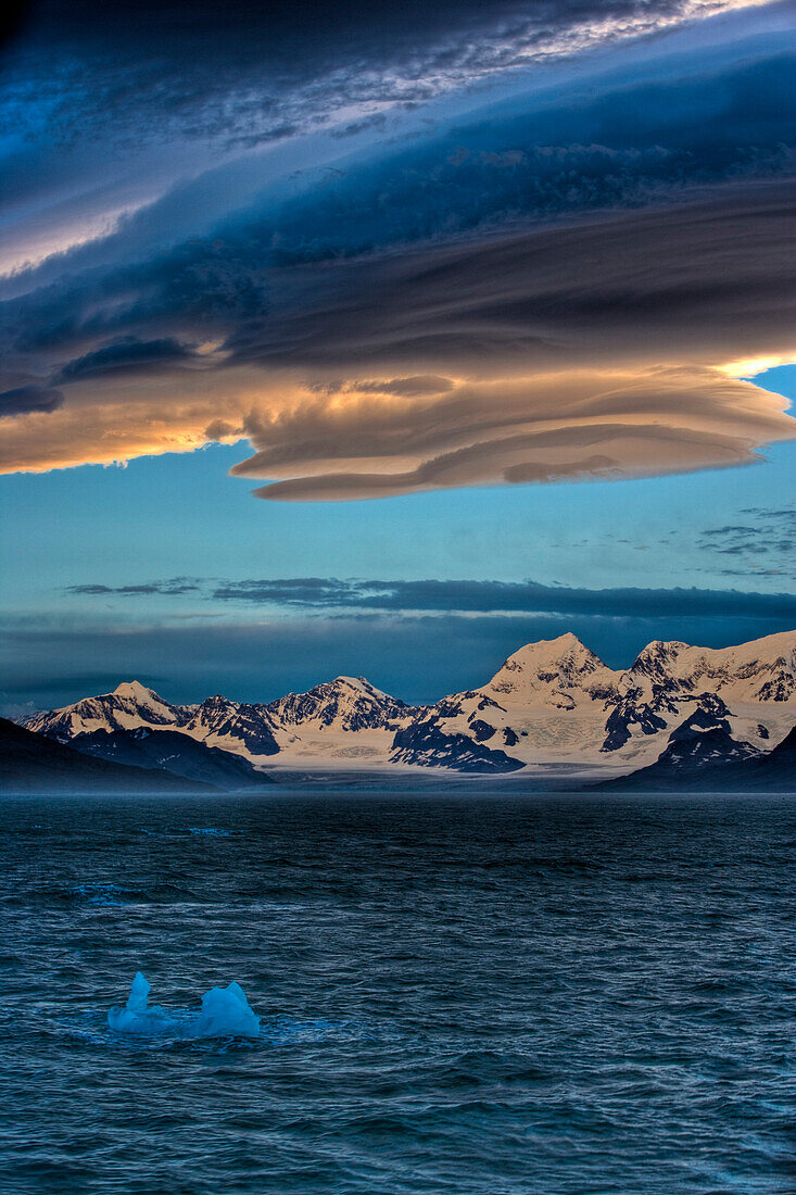 Lenticular clouds above the coast at sunset, South Georgia, Western Asia