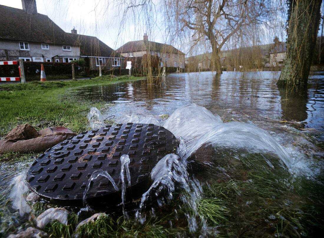 Flood coming up through sewer, River Lavant flooding, West Sussex, England