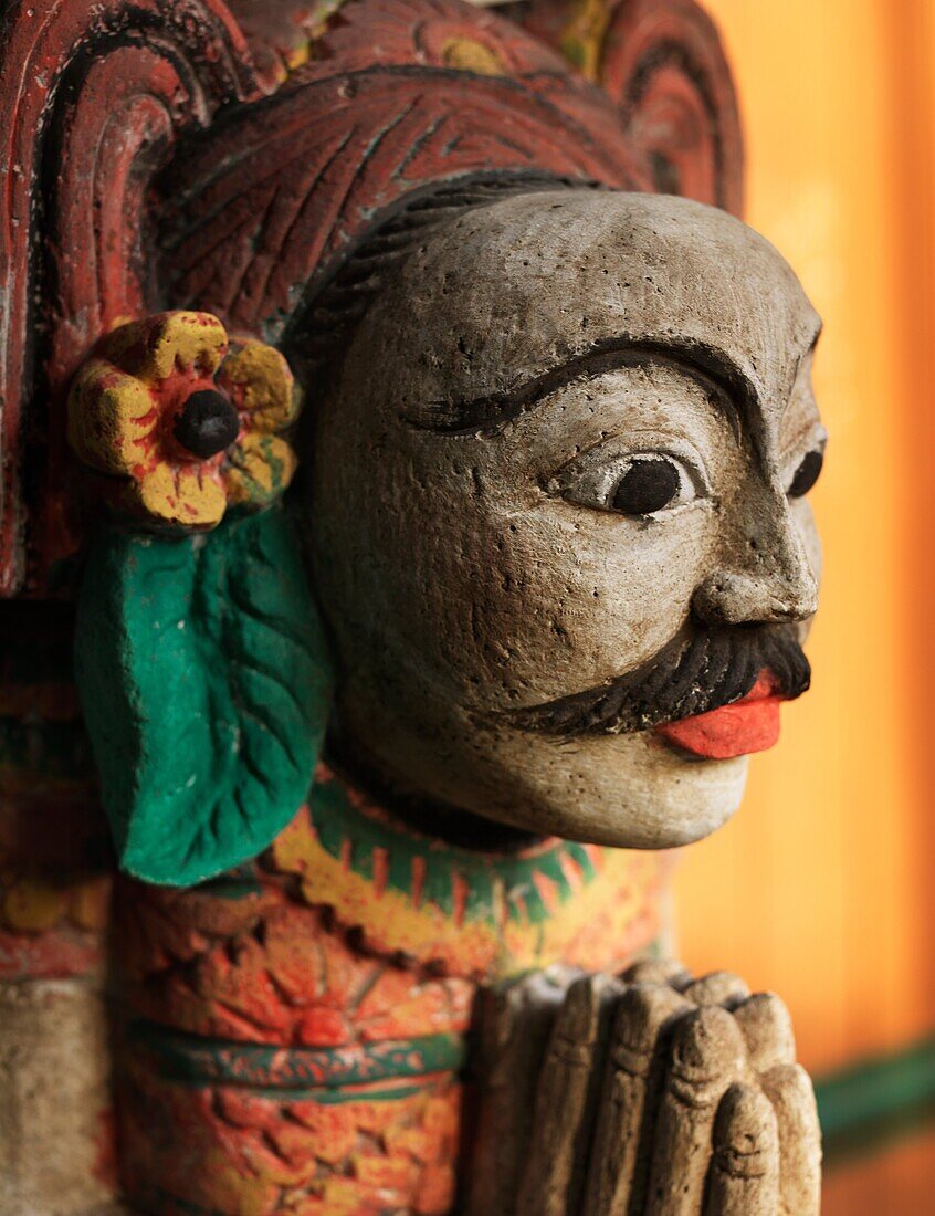 A Balinese stone sculpture in praying postion