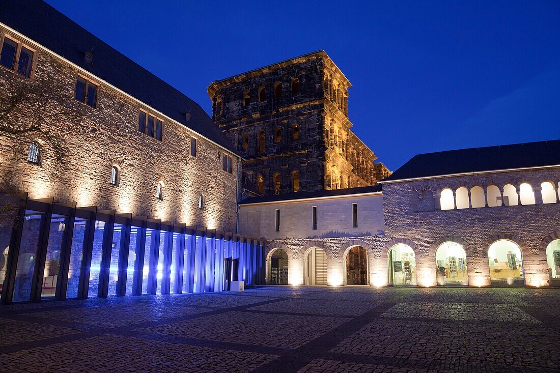 Brunnenhof with Porta Nigra, World Heritage Site, illuminated at night, Trier, Germany