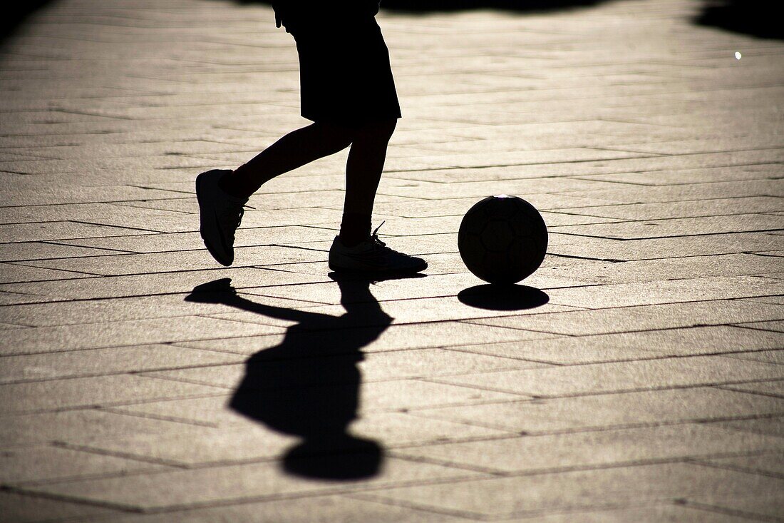 A boy plays soccer in the main square of Merida, Badajoz province, Extremadura region.