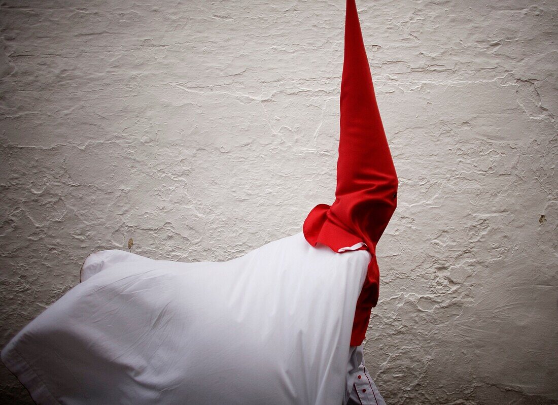 A penitent walks in a street before an Easter Holy Week celebrations in Carmona village, Seville province, Andalusia, Spain, April 19, 2011