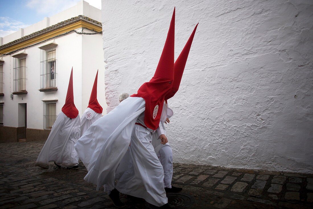 Penitents walk in a street before an Easter Holy Week celebrations in Carmona village, Seville province, Andalusia, Spain, April 19, 2011