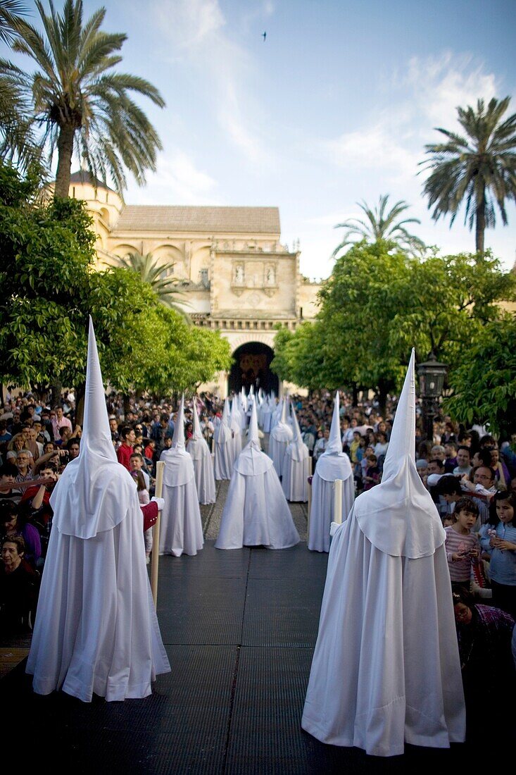 Penitents walk in the Orange Trees Court, Patio de los Naranjos in Spanish, in the Mosque-Cathedral of Cordoba during Easter Holy Week celebrations in Cordoba, Andalusia, Spain, April 18, 2011