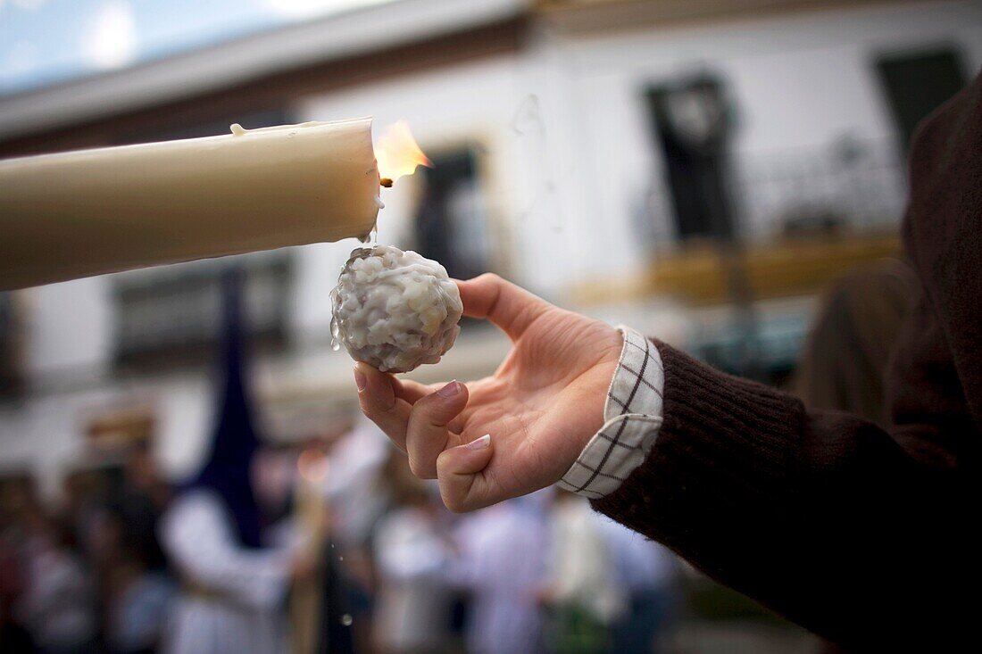 A child makes a wax ball using a candle during an Easter Holy Week procession in Carmona village, Seville province, Andalusia, Spain, April 20, 2011