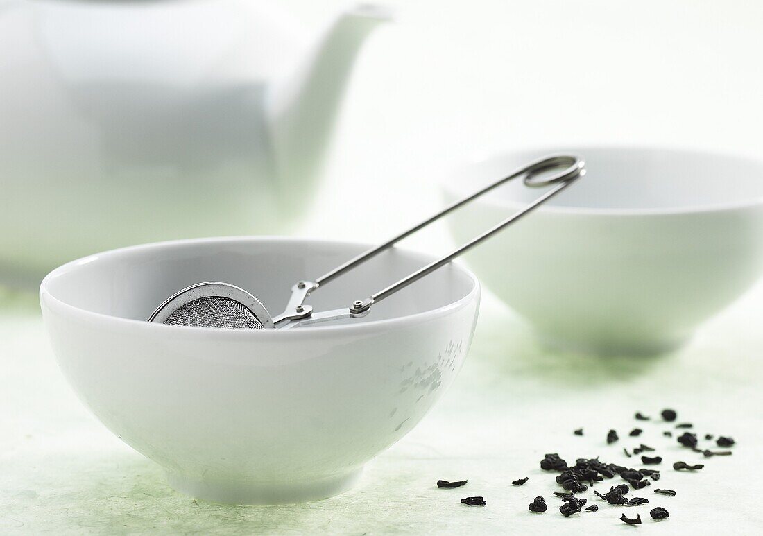 Bowl of green tea, infusion against white background