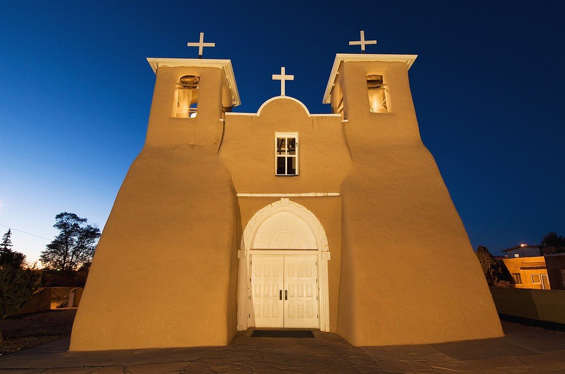 USA, New Mexico, Ranchos de Taos, Old Mission of St  Francis de Assisi also referred to as the Mission of San Francisco de Asis, built about 1710, illuminated in late evening