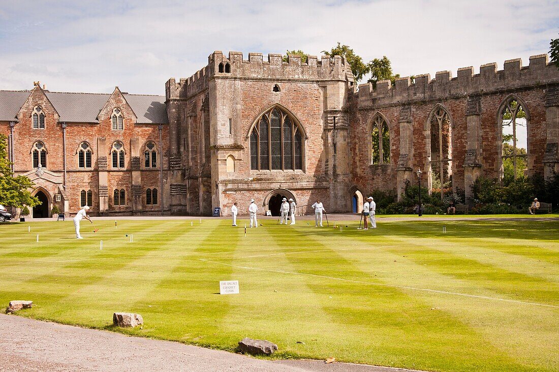 Bishop’s Palace and people playing croquet on the Bishop’s Palace lawn, Wells, Somerset, England