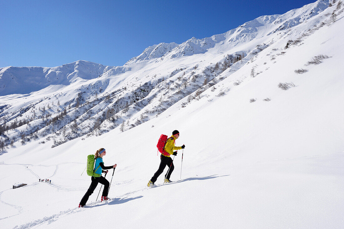 Two cross-country skiers ascending to mount Kreuzspitze, East Tyrol, Tyrol, Austria