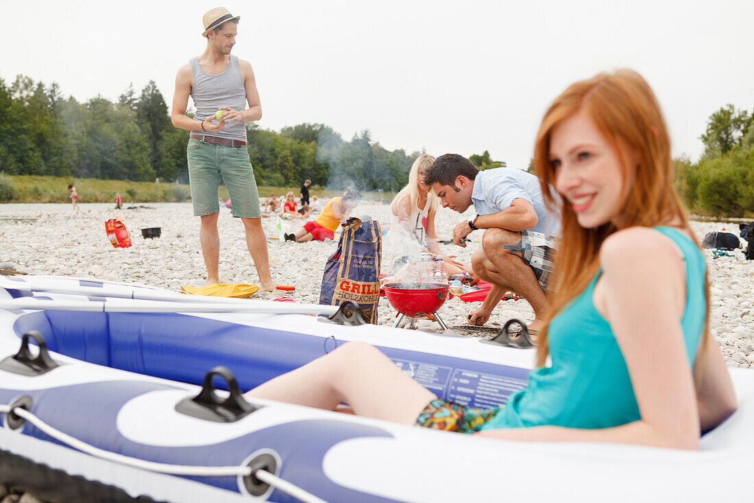 Young people barbecueing on the Isar riverbank, Munich, Bavaria, Germany