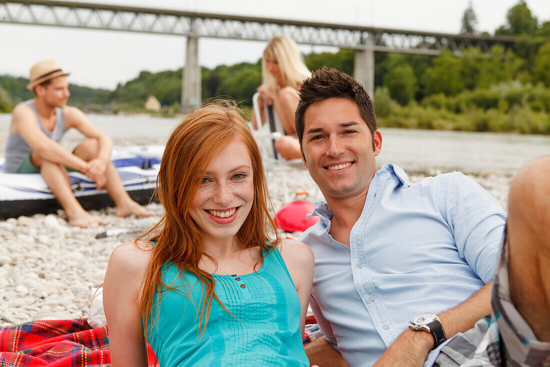 Young people on the Isar riverbank, Munich, Bavaria, Germany