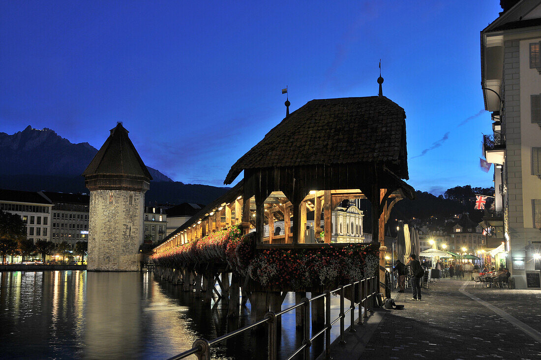 Illuminated Kapellbruecke bridge in the evening, Luzern, Switzerland, Europe