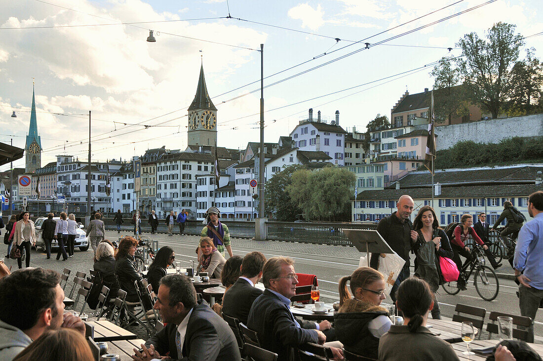People at a street cafe in front of the town hall at Limmat river, Zurich, Switzerland, Europe