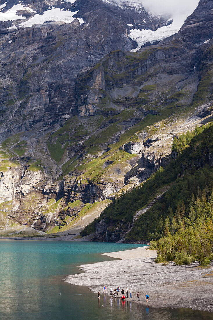 A group of teenagers at lake Oeschinen, Bernese Oberland, Canton of Bern, Switzerland