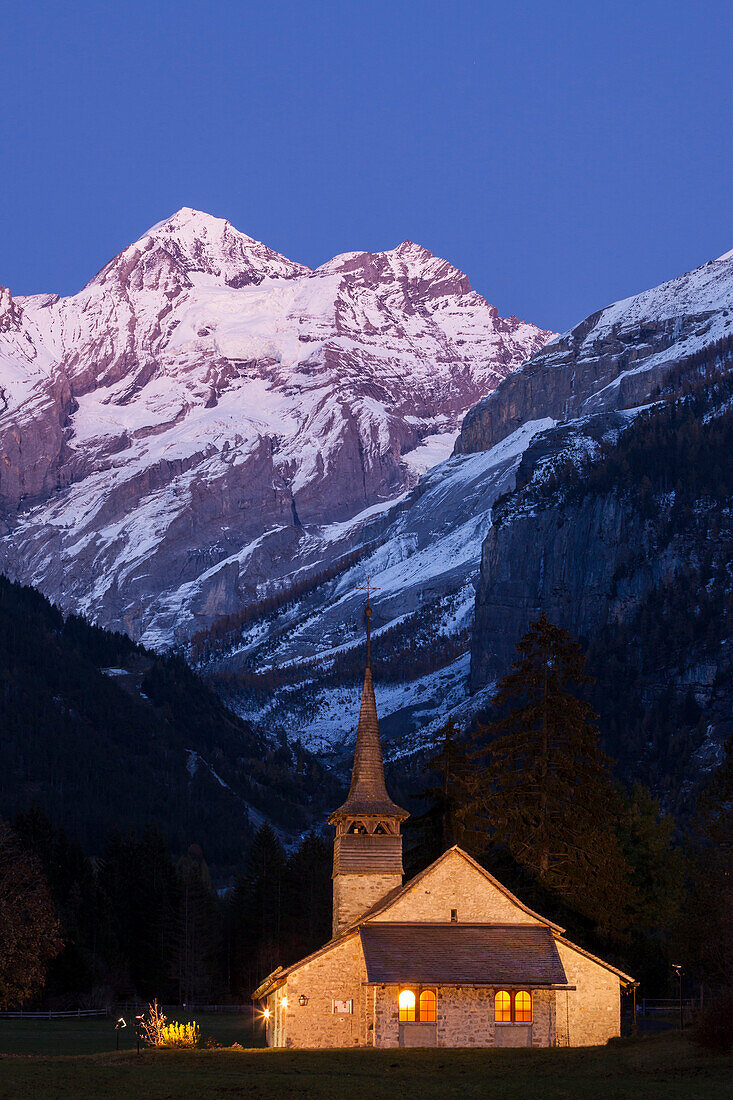 Dusk at the catholic church of Kandersteg and Bluemlisalpmassiv, Bernese Oberland, Canton of Bern, Switzerland