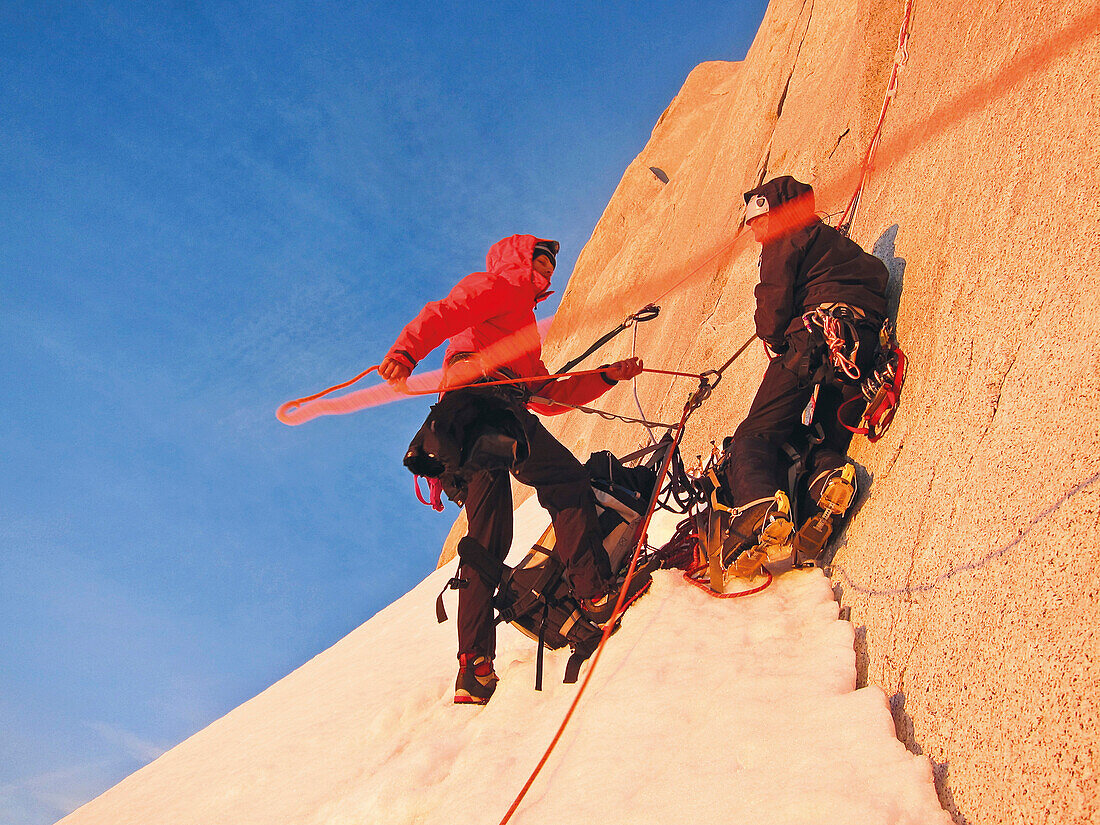 Two men belaying on the Fitz Roy headwall entry, El Chalten, Patagonia, Argentina