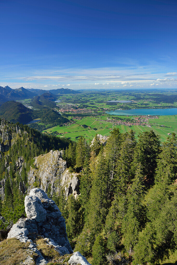 Rock tors at Tegelberg with view towards Fuessen and lake Forggensee, Tegelberg, Ammergau range, Allgaeu, Swabia, Bavaria, Germany