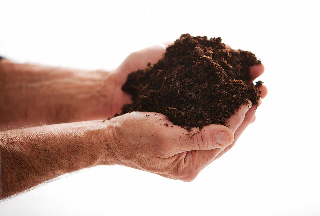 Man holding handfull of soil
