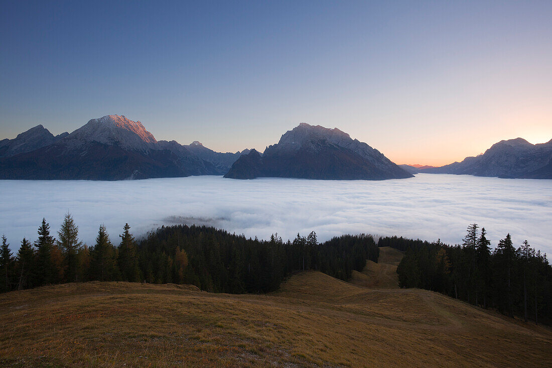 View over the fog in the valley onto Watzmann, Hochkalter and Reiteralpe at dawn, Berchtesgaden region, Berchtesgaden National Park, Upper Bavaria, Germany, Europe