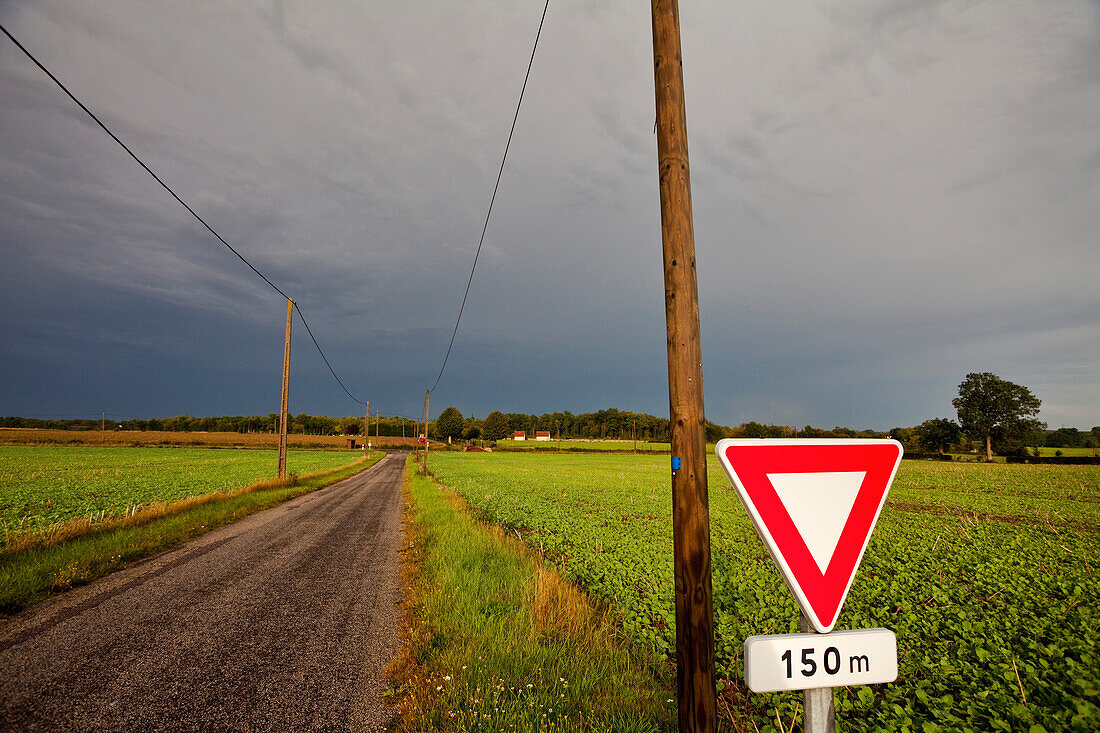 France, Normandy, country road and stormy weather