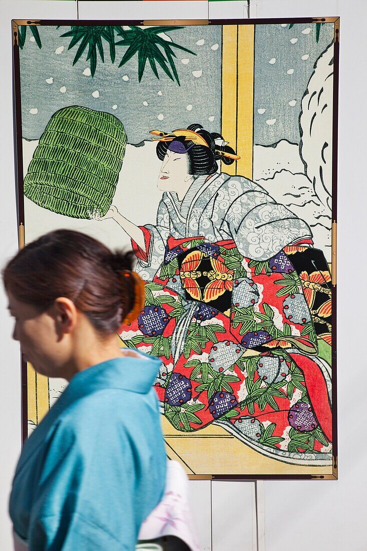 Japan,Tokyo,Ginza,Woman Walking Past Kabuki Advertising Posters