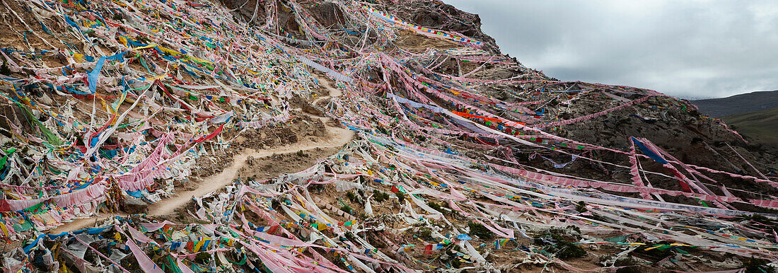 The Kora or pilgrimage route for Buddhists near Princess Wencheng Temple. An important temple and Buddhist place of worship. Sacred. Prayer flags across the mountain.