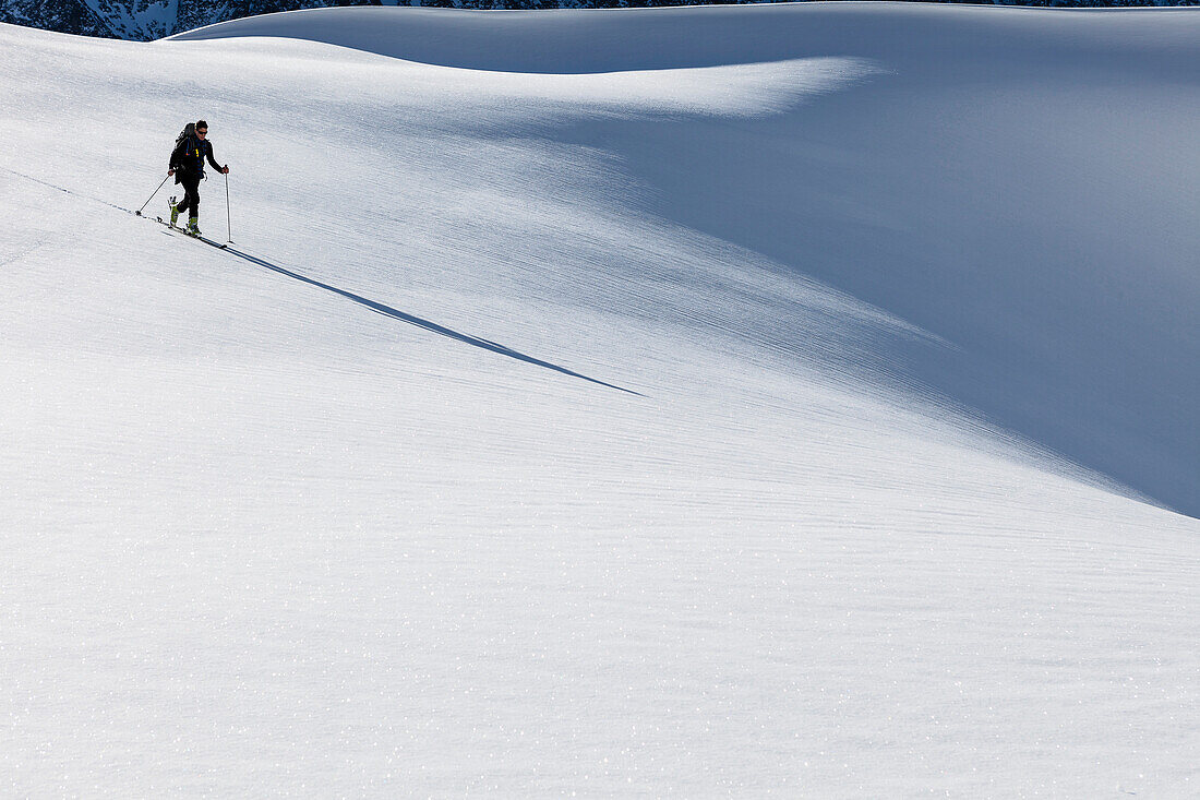 Backcountry skier at Hohe Gruben, ascending Schoentalspitz, Sellrain, Innsbruck, Tyrol, Austria