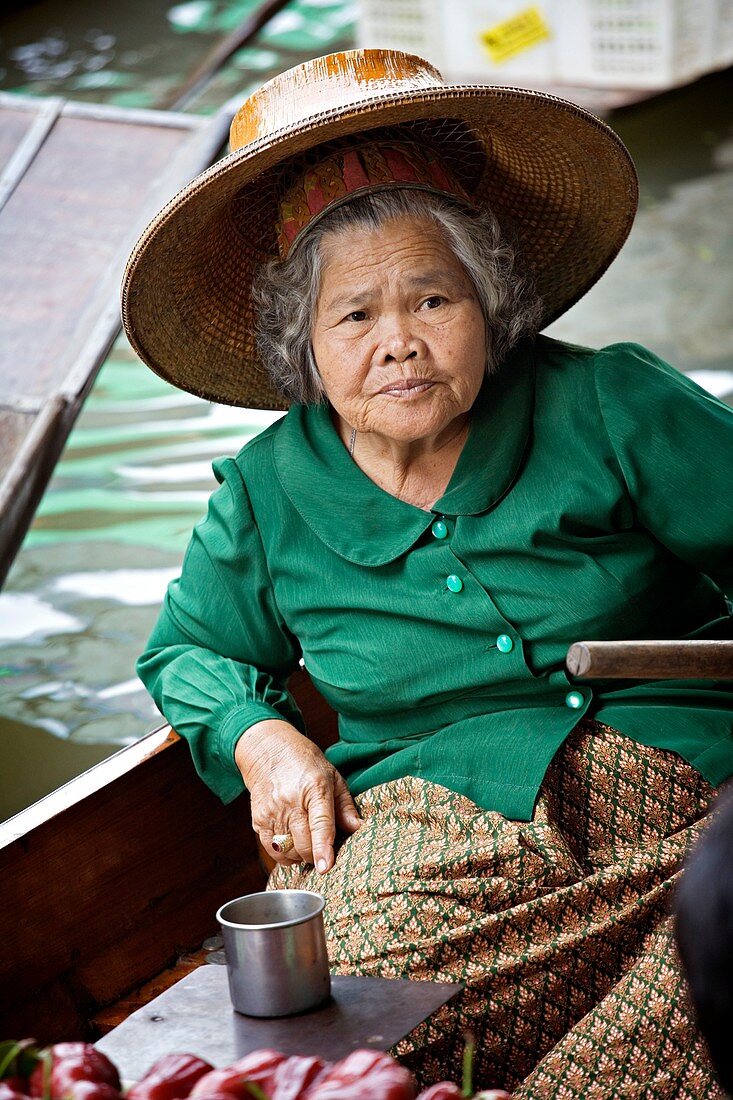 Selling food and souvenirs at the Damnoen Saduak floating market located about 62 miles outside of Bangkok Thailand