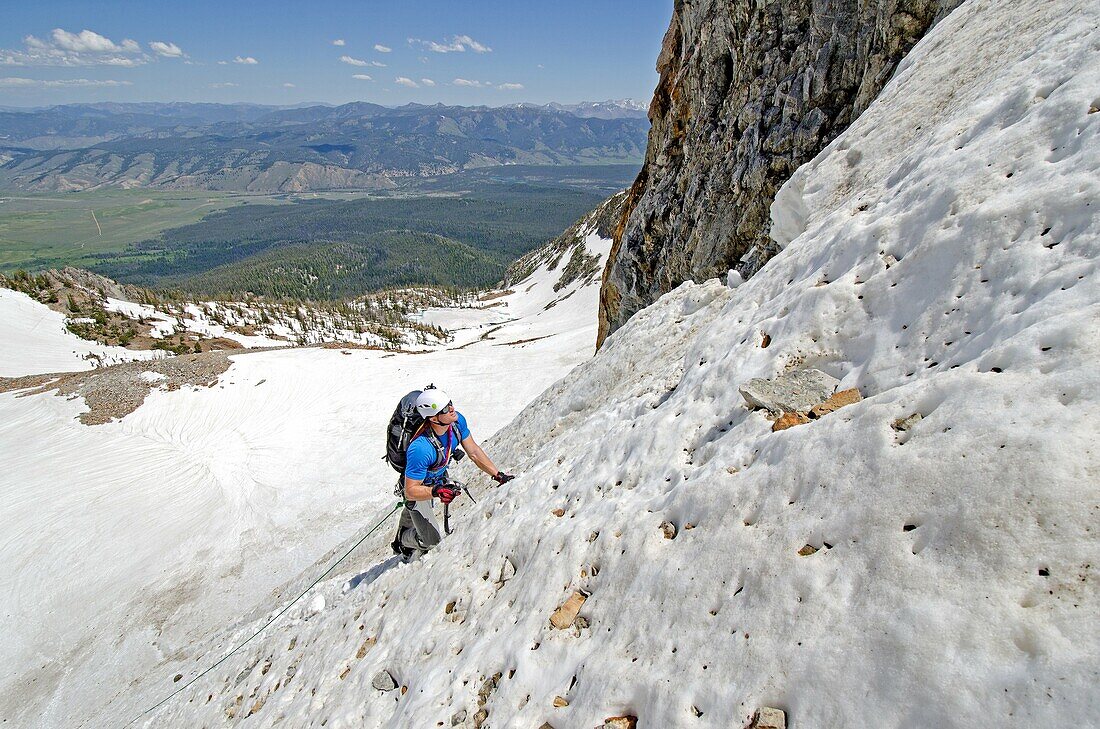 Elijah Weber climbing The June Couloir on the North Face of Williams Peak high above the Sawtooth Valley in the Sawtooth Mountains near the town of Stanley in central Idaho