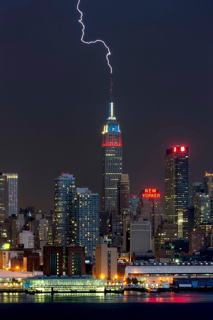 Lightning strikes the antenna on the top of the Empire State Building in New York City during a summer thunderstorm on Thursday, July 26, 2012. The Empire State Building, which is struck by lightning an average of just under 100 times annually, was illumi