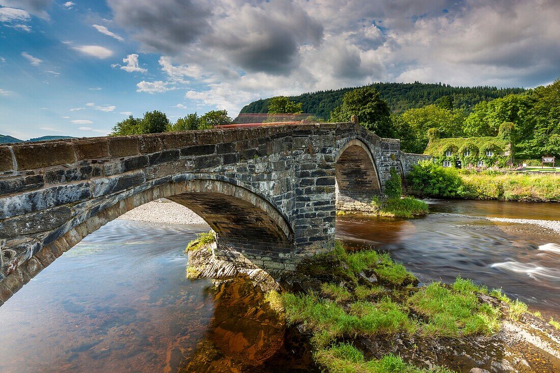 17th century stone bridge over the River Conwy at Llanrwst with the ivy-clad Tu Hwnt i´r Bont National Trust tearooms, The bridge was built in 1636, reputedly by Inigo Jones , Llanrwst, Conwy, North Wales