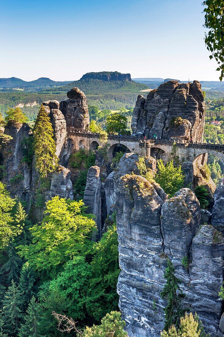 View from Ferdinand stone to the spectacular rock formation Bastei Bastion and Bastei Bridge It is one of the most visited tourist attractions in the Saxon Switzerland Behind it is the Table Mountain Lilienstein He is one of the most striking mountains in