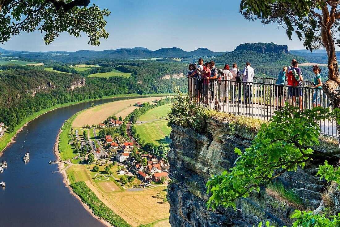 View from the spectacular rock formation Bastei Bastion to health resort Rathen and the Elbe River The Bastei is one of the most visited tourist attractions in the national park Saxon Switzerland In the background is the Table Mountain Lilienstein He is o
