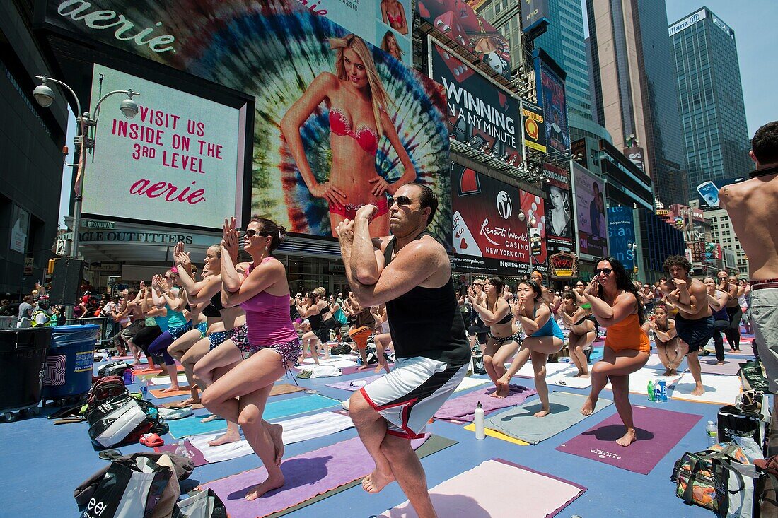 Thousands of yoga practitioners in Times Square in New York participate in a mid-day Bikram Yoga class on the first day of summer Temperatures are expected to rise into the upper 90´s today as most New Yorkers seek relief from the heat