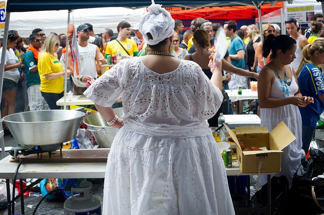 A food vendor fans herself at the 28th Annual Brazil Day Festival in New York The festival, which features food, music and other aspects of Brazilian culture, centers around West 46th Street in Midtown Manhattan, known as Little Brazil