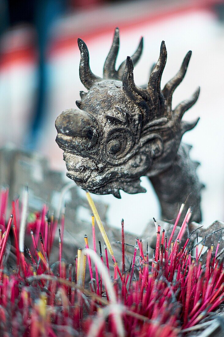 A dragon adornment on the side of an incense alter at the Temple of Literature