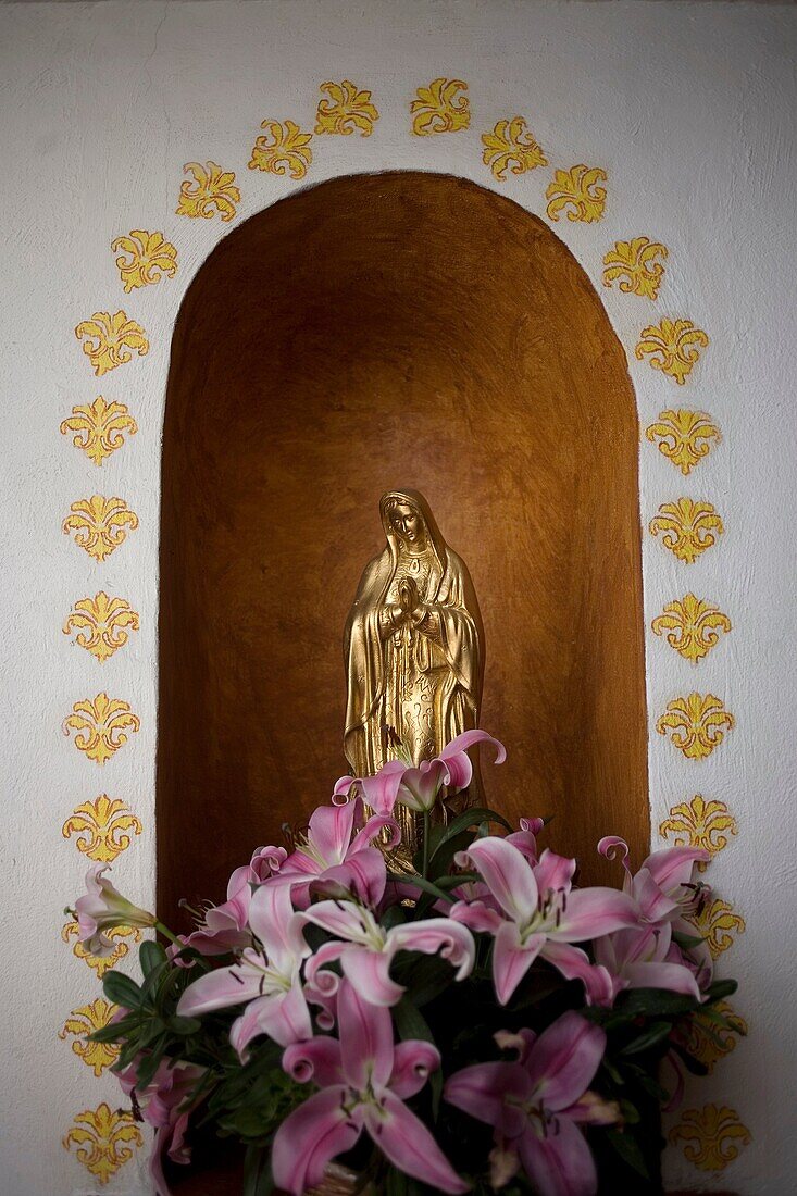 A golden sculpture of the Our Lady of Guadalupe is displayed in Casa de los Frailes hotel in Oaxaca