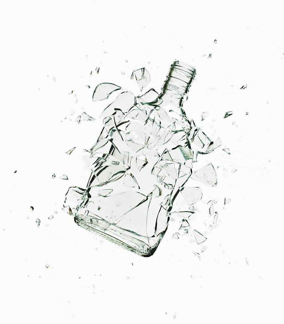 A glass Vodka bottle shattering, exploding. Close up of glass bottle shattering