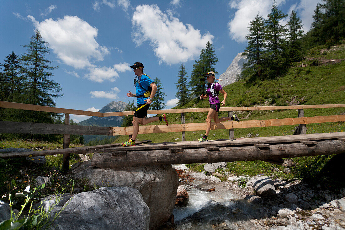 Trailrunning, Trail running, Trail, Ramsau, Dachstein, Styria, Austria, couple, woman, man, bridge, running, walking, run, mountains, brook, dog jogging, sport, fitness, health,. Trailrunning, Trail running, Trail, Ramsau, Dachstein, Styria, Austria, coup