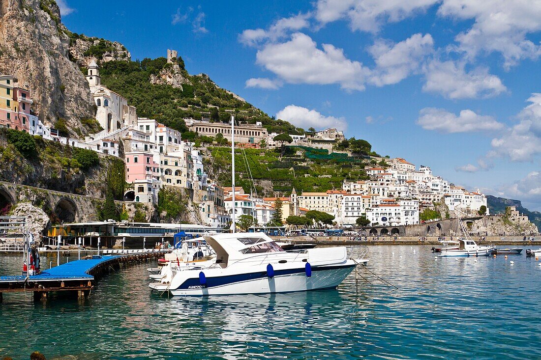 Boats in the harbour and a view of the town of Amalfi on the Gulf of Salerno in southern Italy