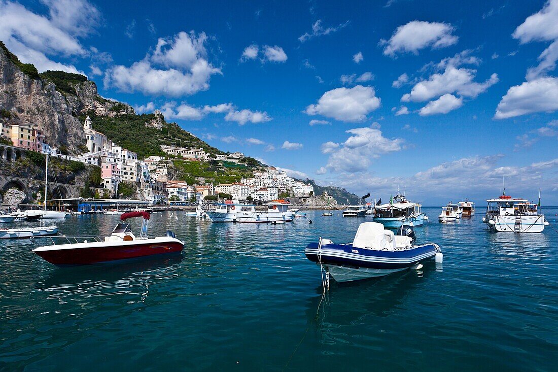 Boats in the harbour and a view of the town of Amalfi on the Gulf of Salerno in southern Italy