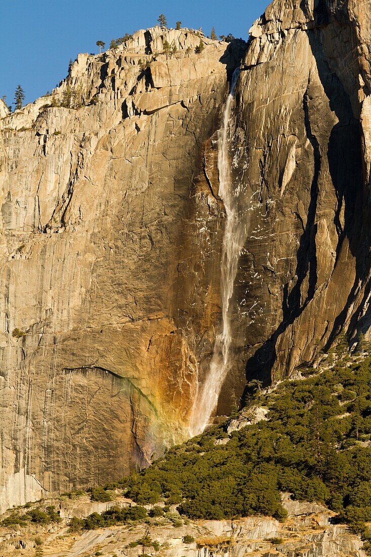 A rainbow appears one fall morning on Upper Yosemite Falls