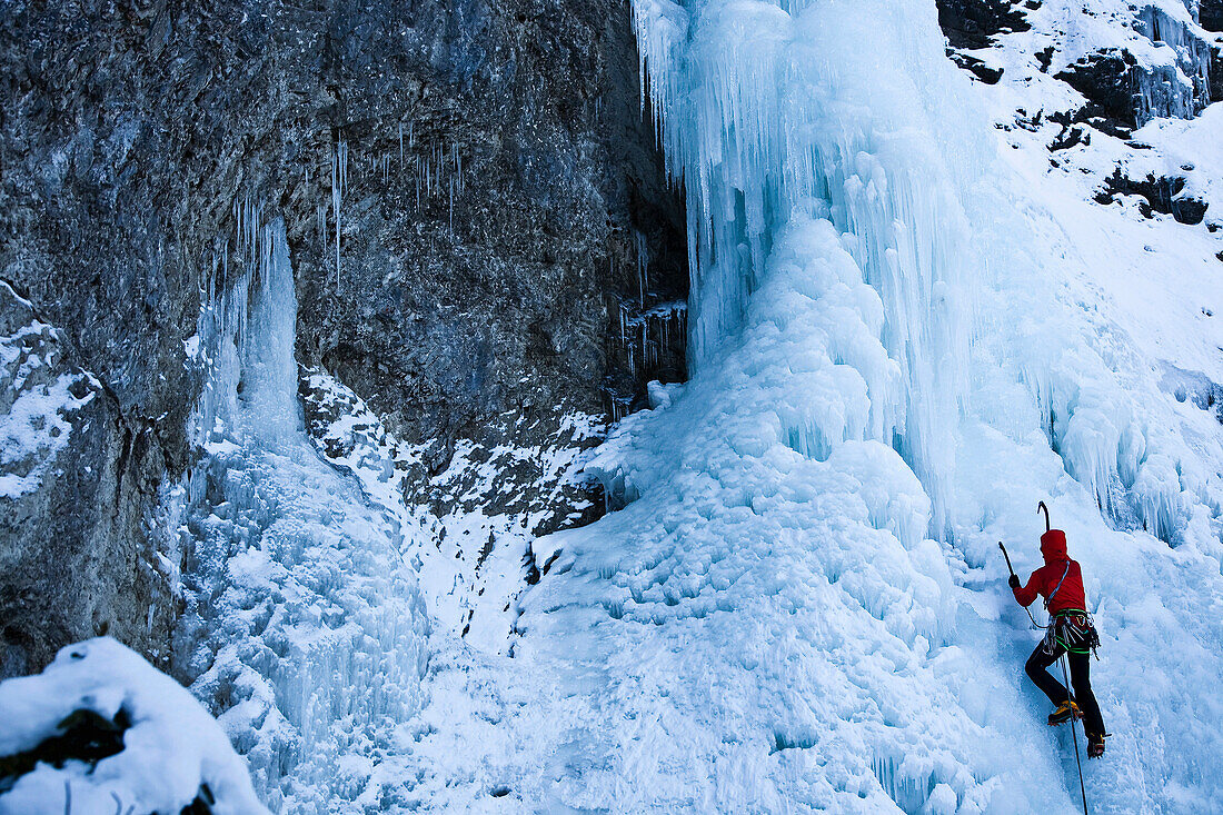 Man ice climbing at the Kotalmfall, Achenkirch, Tyrol, Austria