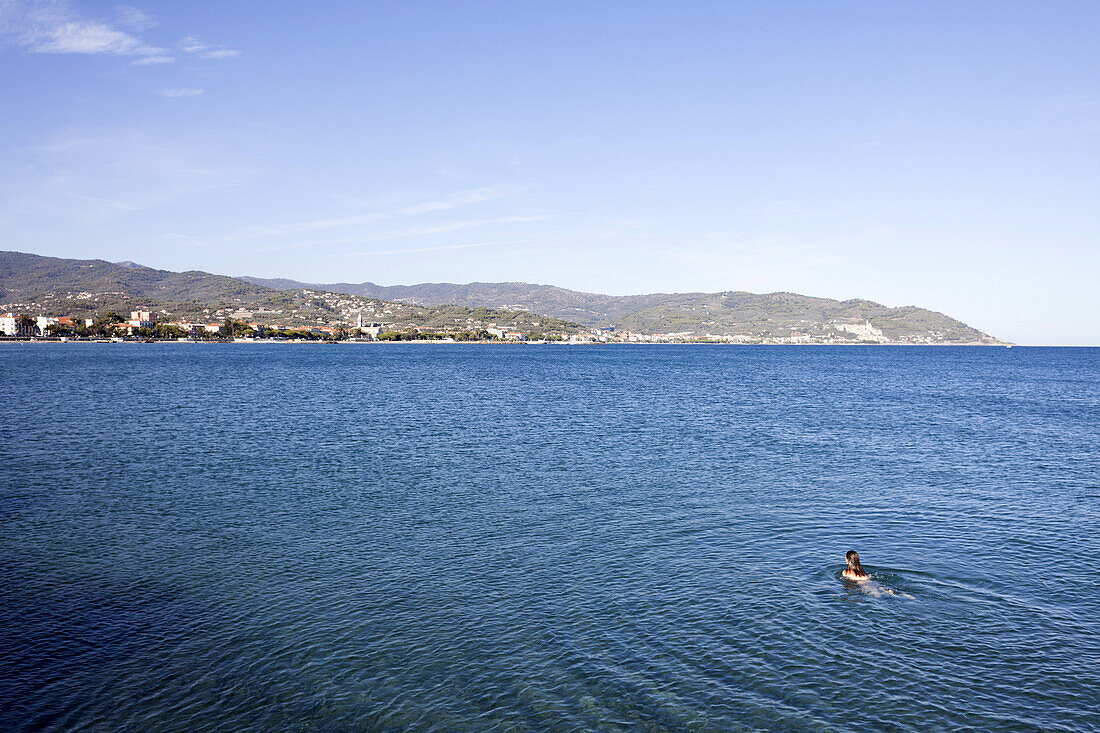 Girl swimming in the Mediterranean sea, Summer holiday, Diano Marina, Imperia, Liguria, Italy