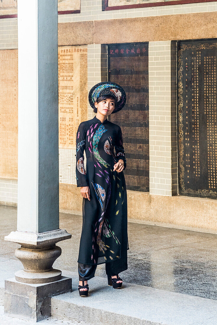 Young woman wearing fashionable traditional clothes in the Thien Hau pagoda in Saigon, south Vietnam, Vietnam, Asia