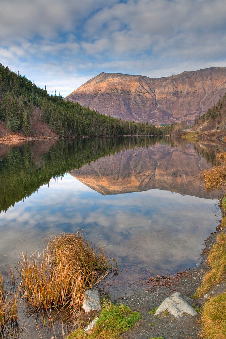 View of mountains reflected in Jerome Lake near the juction of Seward and Sterling Highways, Kenai Peninsula, Southcentral Alaska, Fall, HDR image