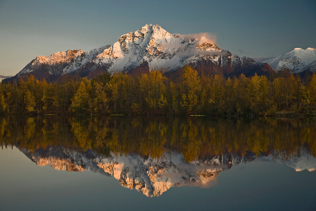 Scenic view of Pioneer Peak reflecting in Echo Lake at sunset, Southcentral, Alaska