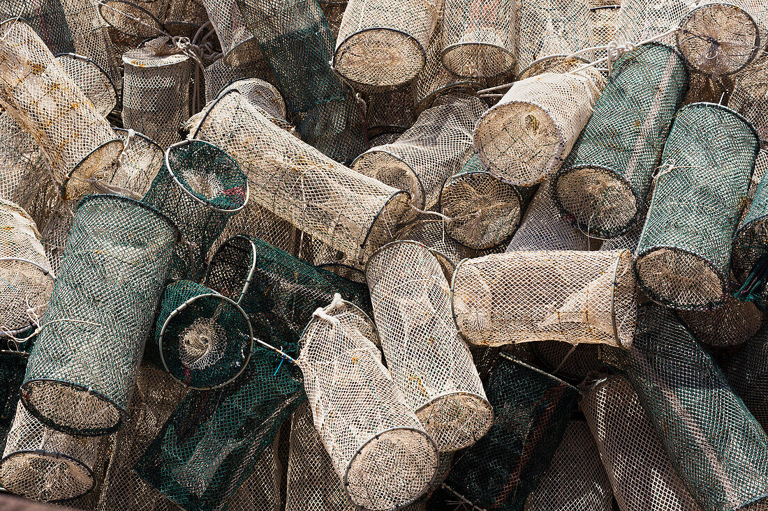 Shrimp traps heaped up on the wharf of the Temo River, in Bosa. Nets and traps. Fishing gear.