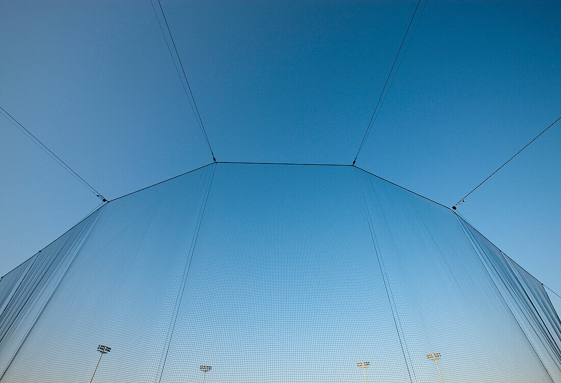 A tall screen at a stadium. Material covering, overhead protection.