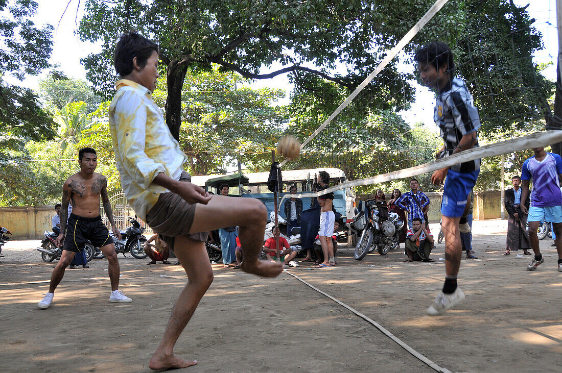 Young man playing football, Southeastasian football, Mandalay, Myanmar, Burma, Asia
